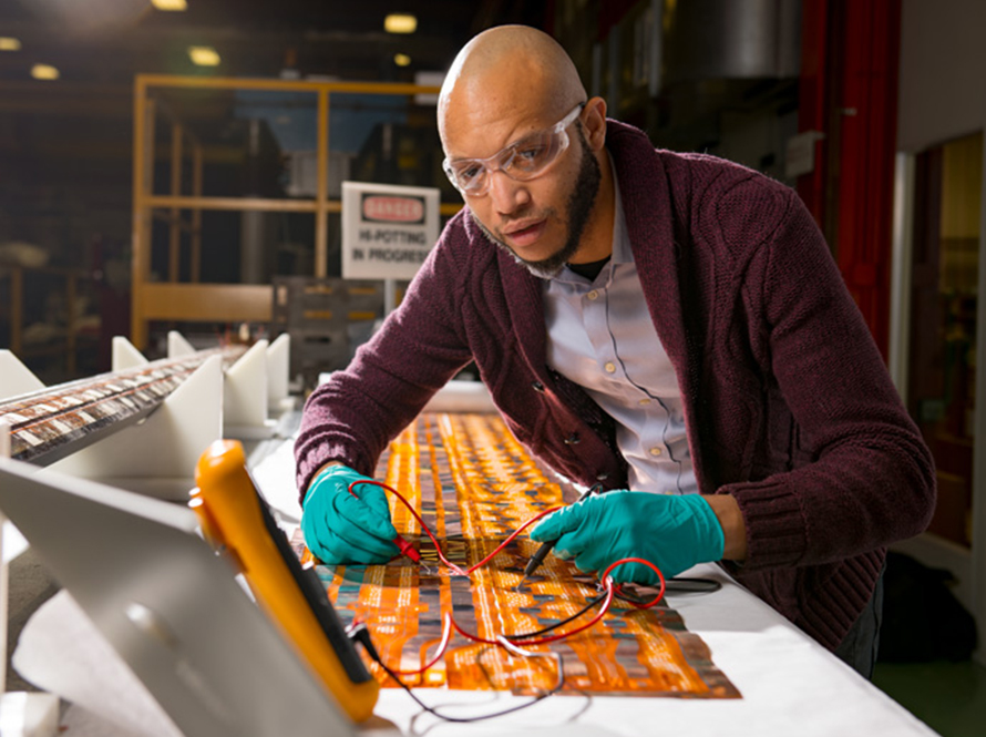 Technician connecting probes to circuit