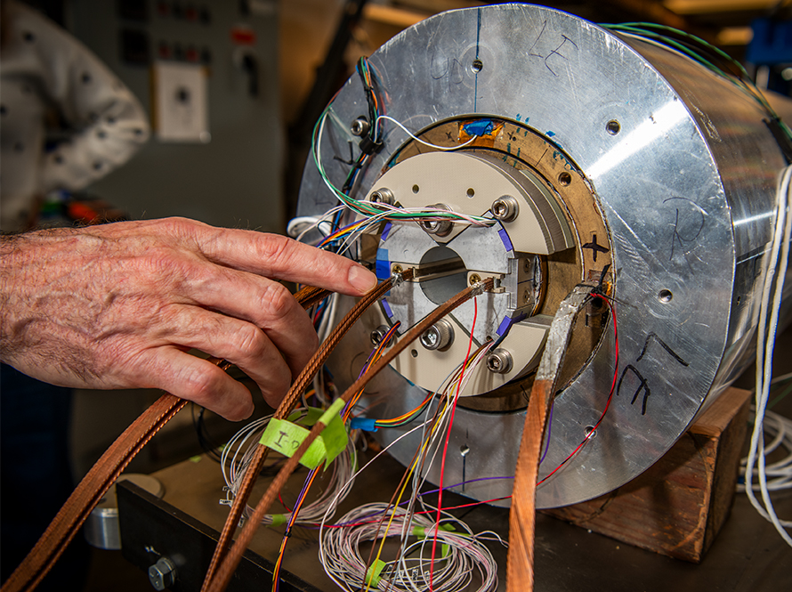Researcher’s hand as he works with superconducting magnet