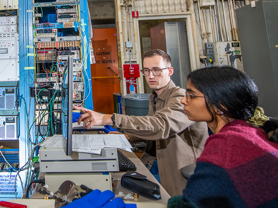 Two researchers at a computer screen